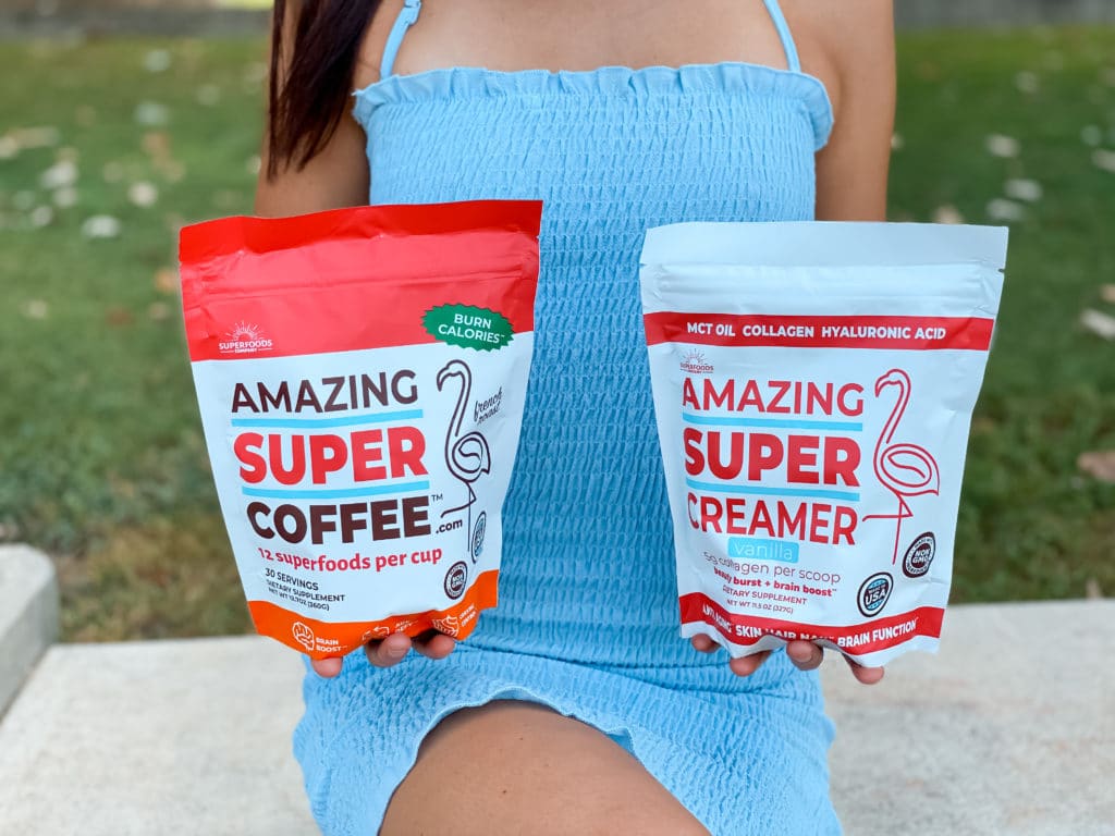 Woman holding Super Amazing Coffee and Super Amazing Creamer. 