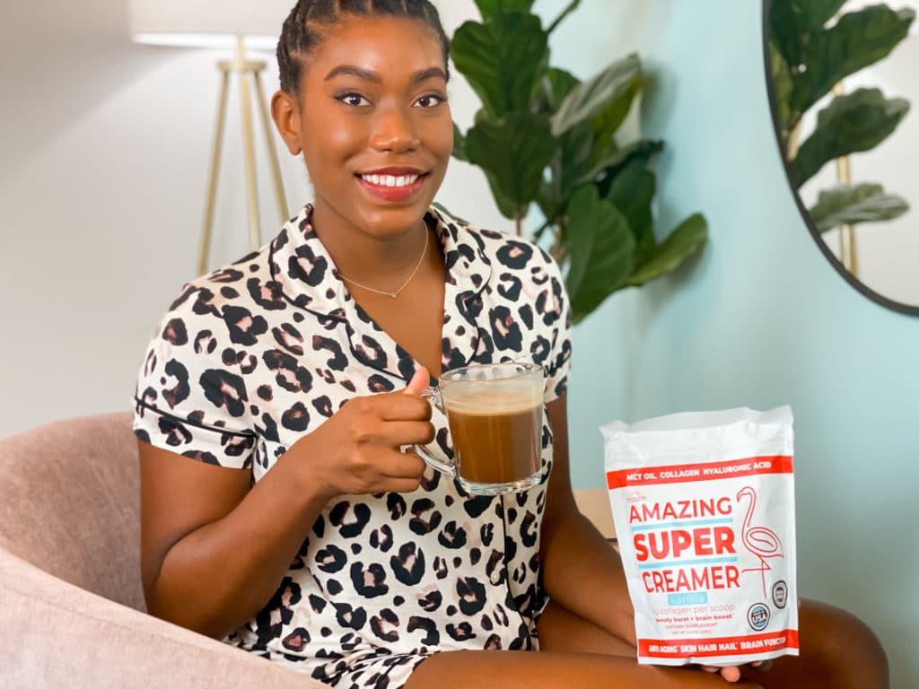 Woman drinking a cup of coffee with Super Amazing Creamer 
